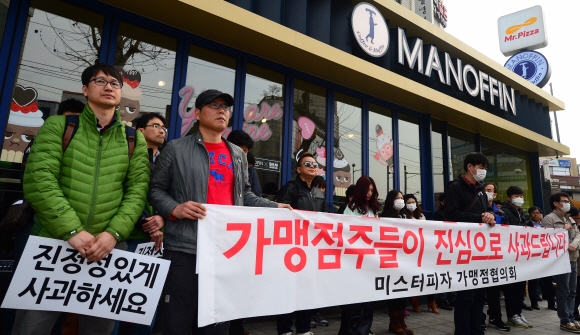 경비원 폭행 논란을 빚고 있는 정우현 미스터피자(MPK그룹) 갑질논란과 관련해 가맹점주의 추가폭로가 이어지는 가운데 6일 서울 서초구 방배동 MPK그룹 본사 앞에서 가맹점주협의회가 ’진정성있게 사과하세요’라고 씌인 종이를 들고 있다. 2016. 4. 6. 박윤슬 기자 seul@seoul.co.kr
