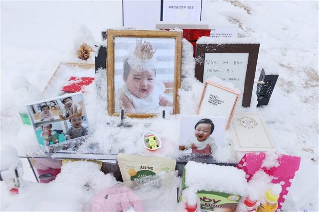 지난 13일 경기 양평군 하이패밀리 안데르센 공원묘원에 양부모의 학대로 생후 16개월 만에 사망한 정인 양을 추모하는 시민들이 정인 양 사진 곁에 선물과 편지 등을 남겼다. 연합뉴스