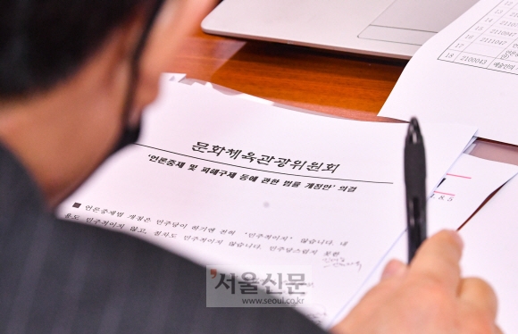 윤상현 국민의힘 의원이 10일 국회 문화체육관광위원회 전체회의에서 ‘징벌적 손해 언론중재법 개정안’ 자료를 살펴보고 있다. 김명국 선임기자 daunso@seoul.co.kr