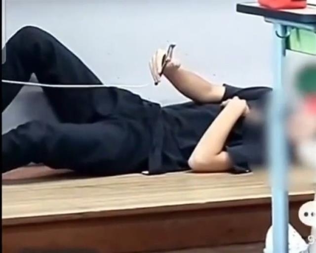 수업 중 교단에 누운 학생. 사회관계망서비스 영상 캡처