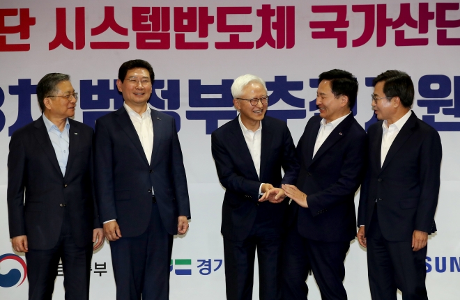 27일 오후 경기 용인시 삼성전자 기흥캠퍼스에서 열린 ‘용인 첨단 시스템반도체 국가산단 성공을 위한 제3차 범정부 추진지원단 회의 및 협약식’에 참석한 원희룡(오른쪽 두 번째) 국토교통부 장관이 경계현(가운데) 삼성전자 사장에게 자리를 양보하고 있다. 오른쪽은 김동연 경기도지사. 연합뉴스
