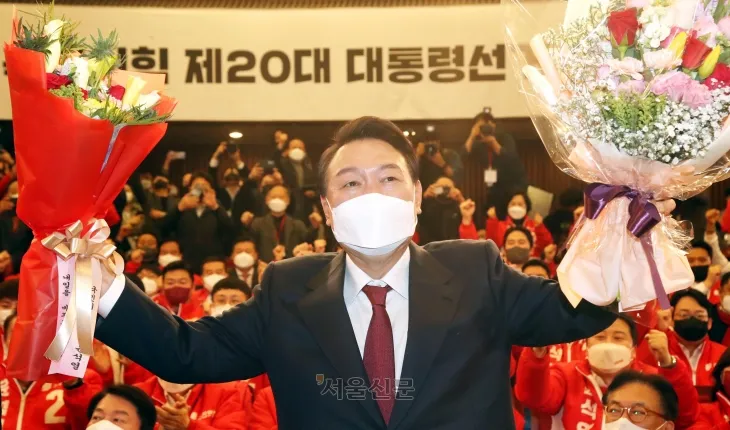 윤석열 대통령 당선인이 10일 새벽 서울 여의도 국회도서관에 마련된 ‘국민의힘 제 20대 대통령선거 개표상황실’을 찾아 꽃다발을 받고 있다.2022.3.10. 정연호 기자 윤석열 대통령 당선인이 10일 새벽 서울 여의도 국회도서관에 마련된 ‘국민의힘 제 20대 대통령선거 개표상황실’을 찾아 꽃다발을 받고 있다.2022.3.10. 정연호 기자